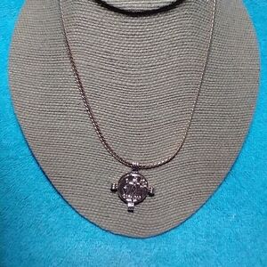 Goldtone coin necklace on serpentine chain